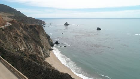 Aerial-Drone-Stock-Video-of-Bixby-Bridge-Highway-with-water-and-shore-below-in-Big-Sur-Monterrey-California