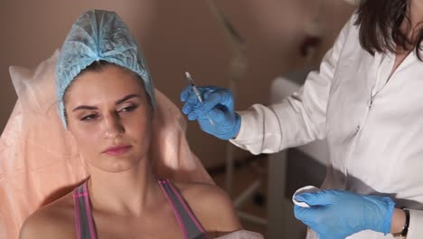 woman getting facial injection in a clinic