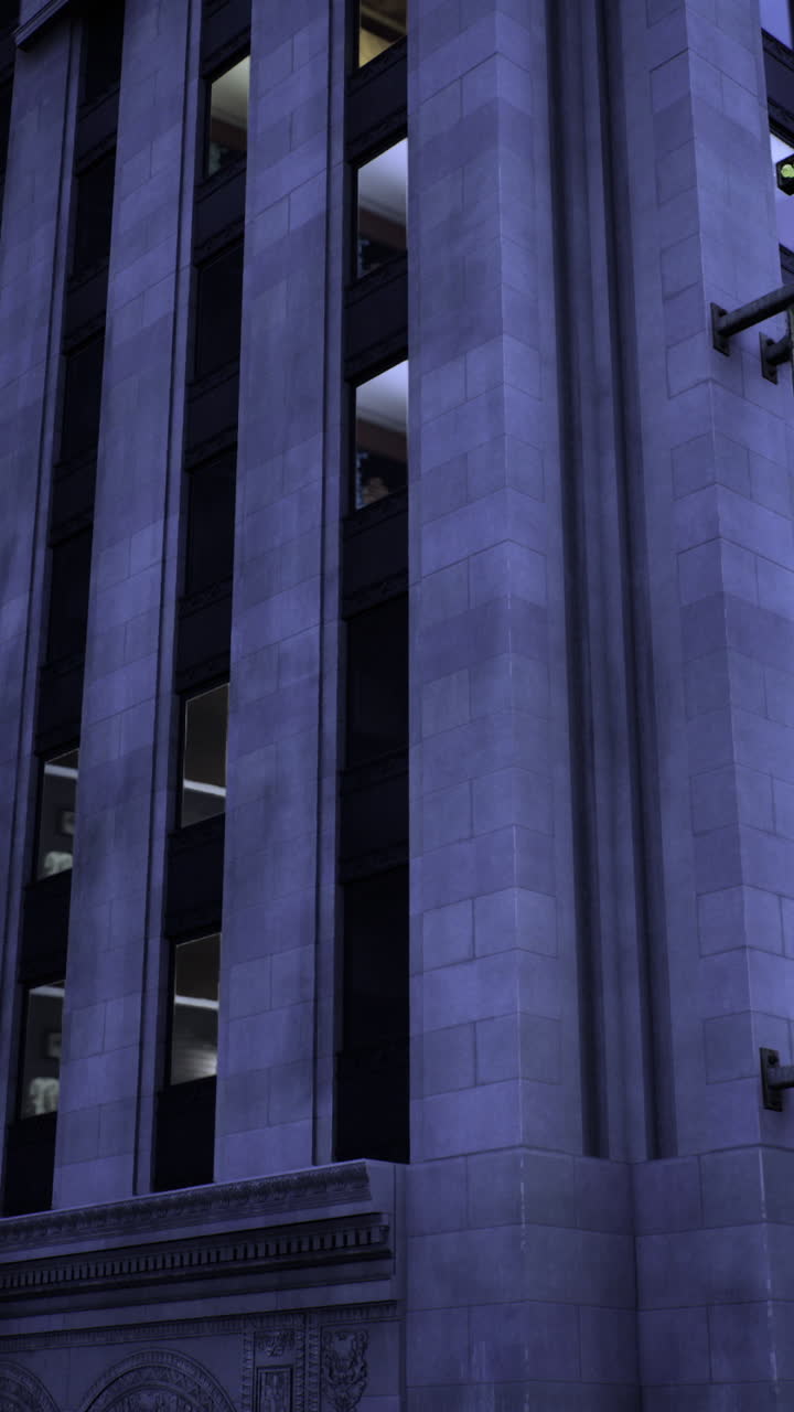 Historic theater illuminated at night in a bustling city center