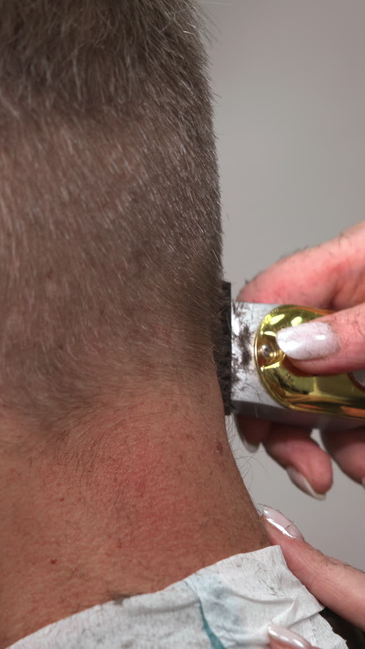 Close-up of Man's Neck Hair Being Trimmed with Electric Clippers