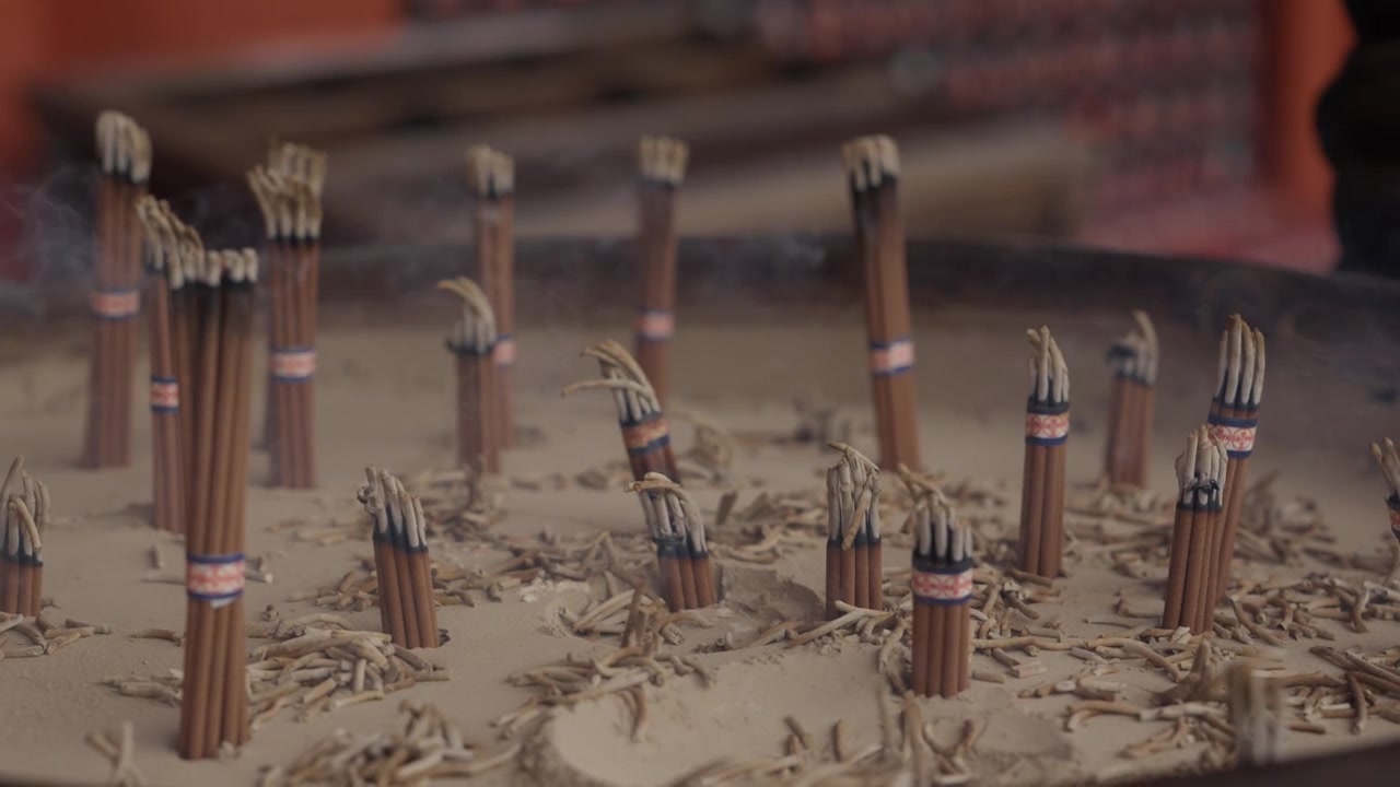 Bundles of incense sticks placed upright in sand burner at Buddhist temple Japan