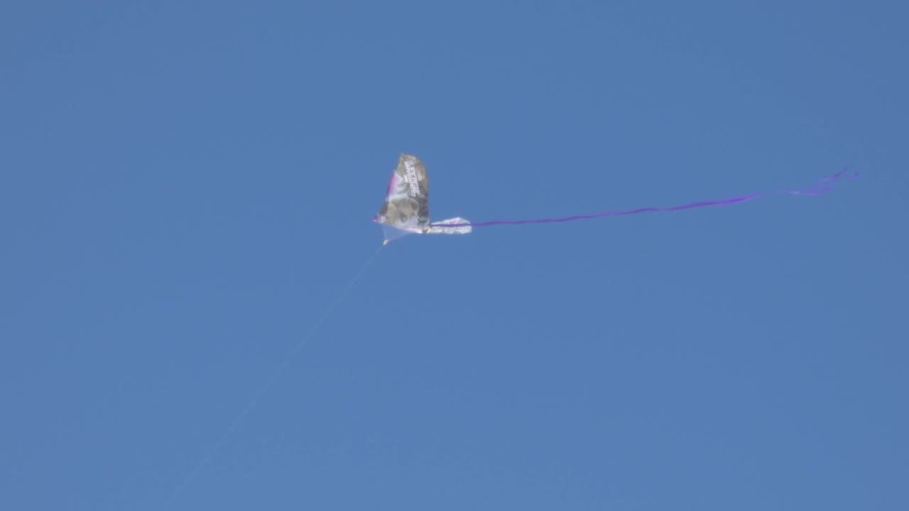 Flying a kite on a windy day with blue skies