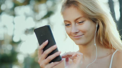 stylish women in sunglasses use a smartphone on vacation the rays of the sun beautifully illuminate