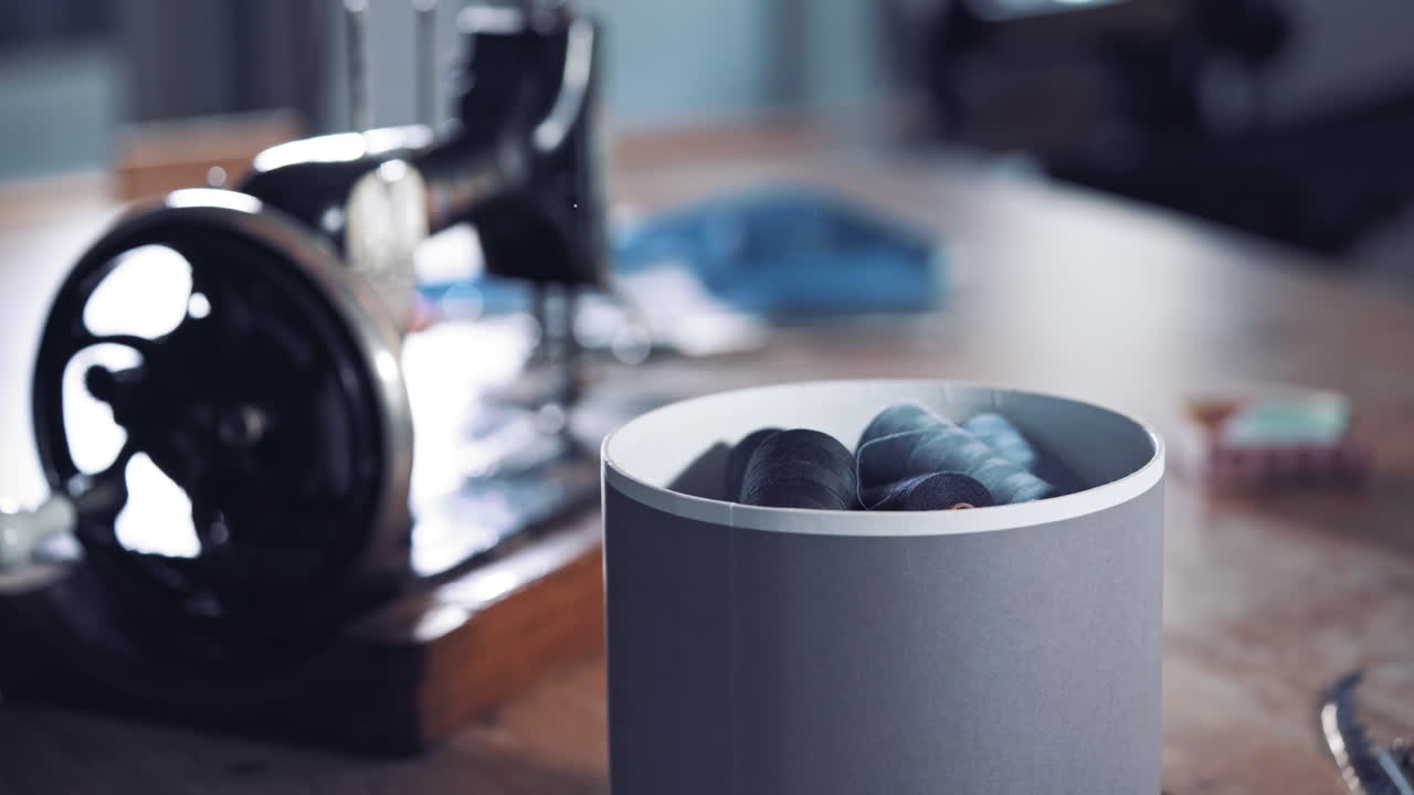 Box with thread spools. Close up view with many sewing threads against workshop