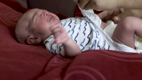 newborn baby crying and moving hands and legs, adorable asian boy