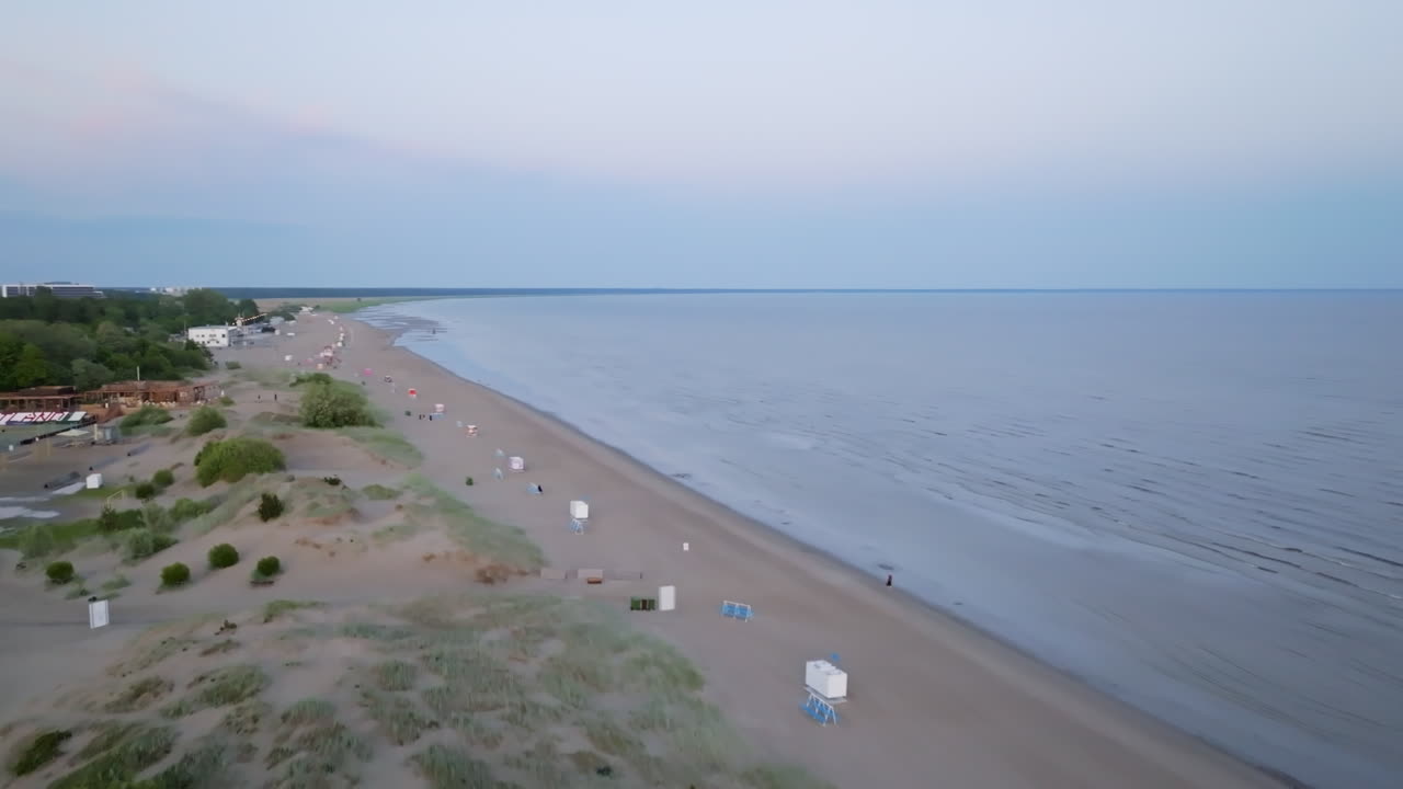 Aerial view rotating along the Parnu beach, warm, summer evening in Estonia