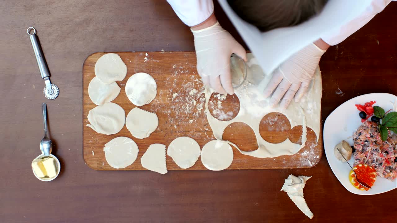Preparing dumplings, cutting dough into circles