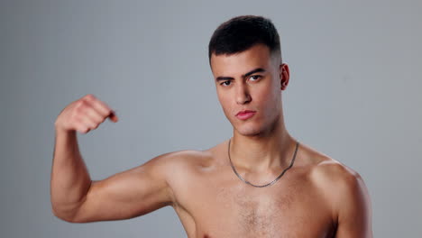 shirtless man flexing his muscles