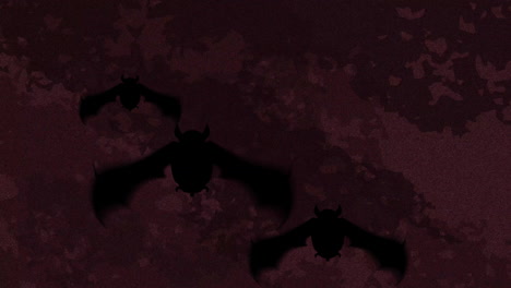 animation of silhouettes of bats over moving shapes on black background