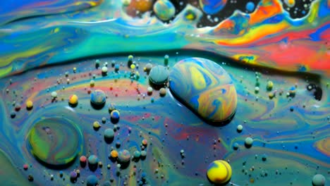 slow motion bright colors bubbles oil beautiful paint universe color moving multicolored closeup. acrylic paint. fantastic surface. abstract colorful paint metamorphosis structure colorful bubbles