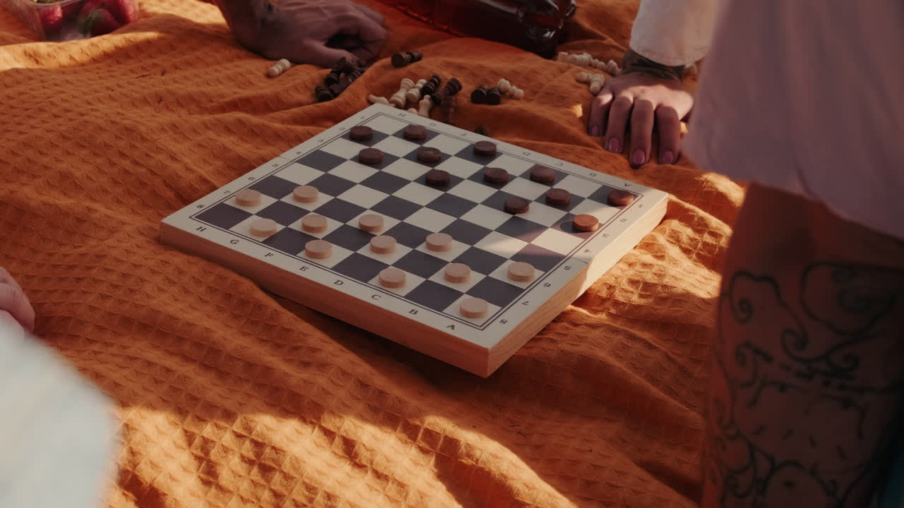 Friends Playing Checkers at a Picnic