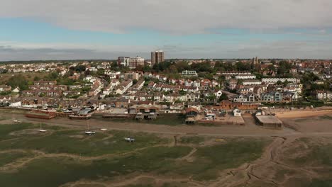 Sweeping-shot-from-right-to-left-of-coastal-fishing-village-over-marshes