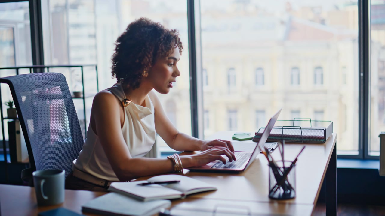 Businesswoman typing laptop office. Focused african american woman remote work