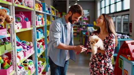 couple shopping for pet supplies with a puppy in a pet store