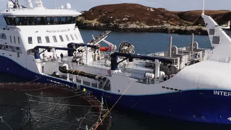 Drone-shot-of-the-deck-of-a-well-boat-being-operated-by-fishermen