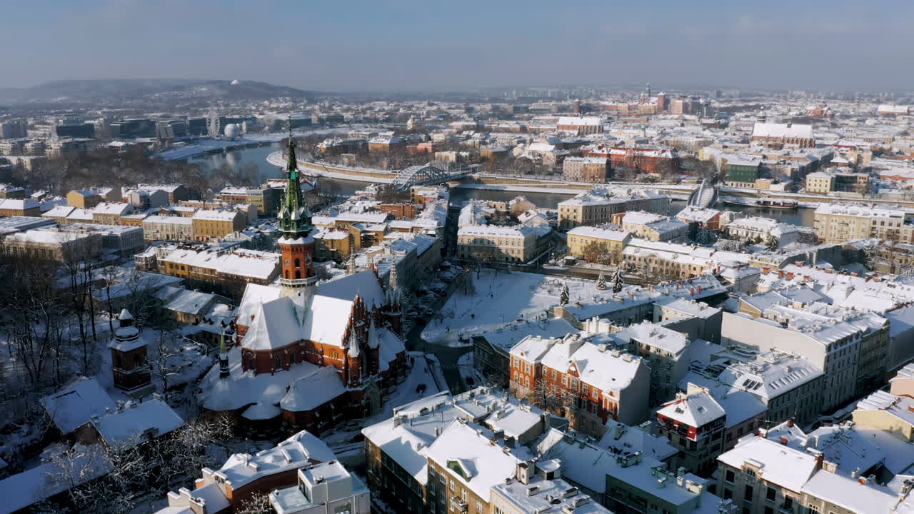 Panorama of snow covered Podgorze district with tenement houses (Podgorski Square with St. Joseph's Church) in Krakow, Poland