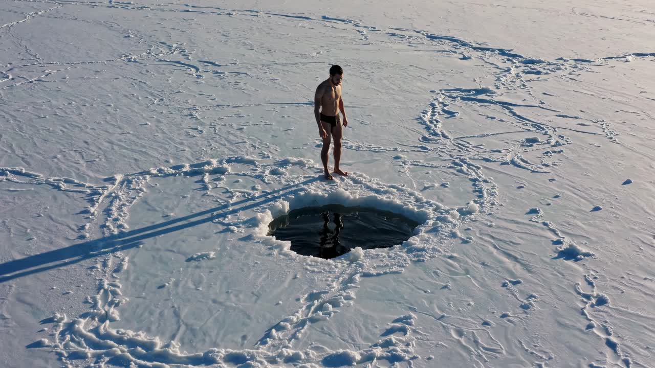 Man ice swimming in winter