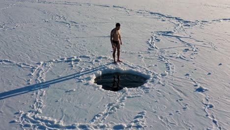 man ice swimming in winter