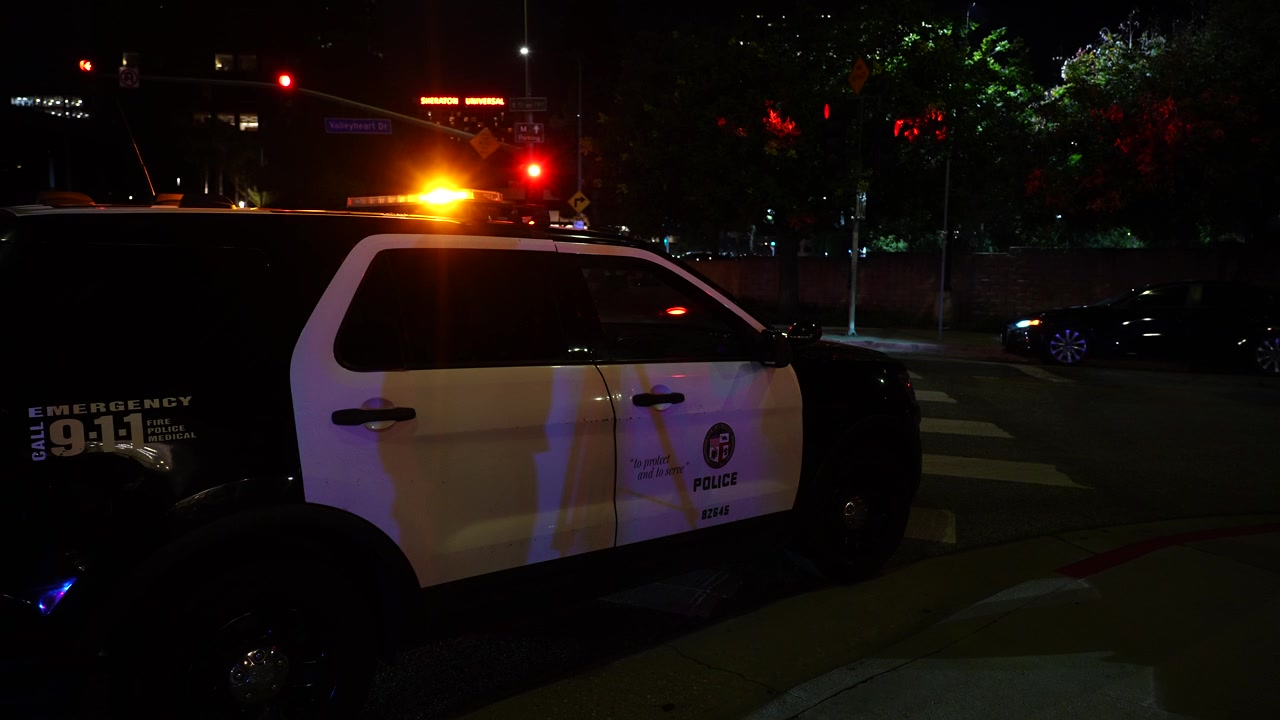 Police Car on Street at Night with Flashing Amber Lights