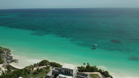 tulum ruins on the edge of the crystal clear waters of the caribbean ocean
