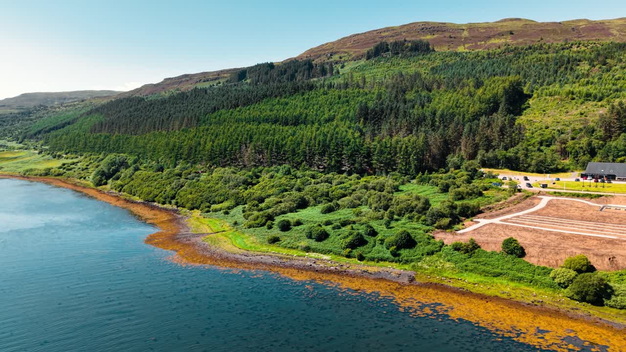 Aerial View of a Picturesque Lake Surrounded by Lush Green Forest and Mountains