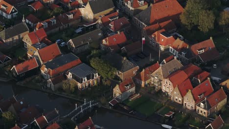 Aerial-drone-view-of-small-village-with-orange-roofs,-Hindeloopen,-Friesland