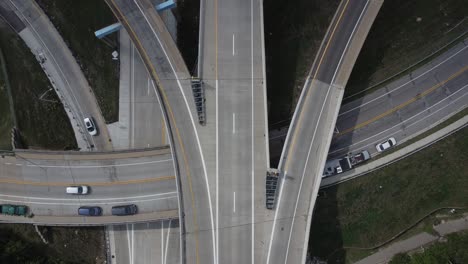 aerial drone video of traffic driving through a busy highway intersection