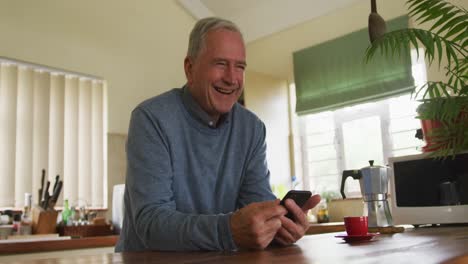 Senior-man-using-mobile-phone-at-home