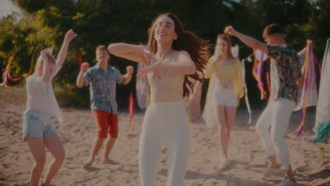 carefree young female brunette grooving to music against friends