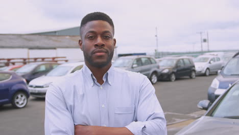 portrait of insurance loss adjuster inspecting damage to car from motor accident