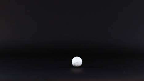 golf ball moves across a dark background