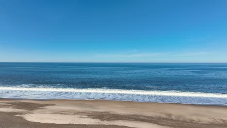 low angle view of the north sea from the beachside is breathtaking, offering a wide expanse of shimmering water and the horizon stretching endlessly.