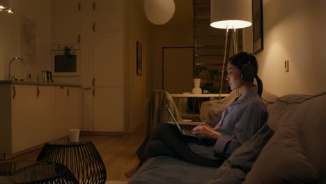 woman working from home on a laptop at night