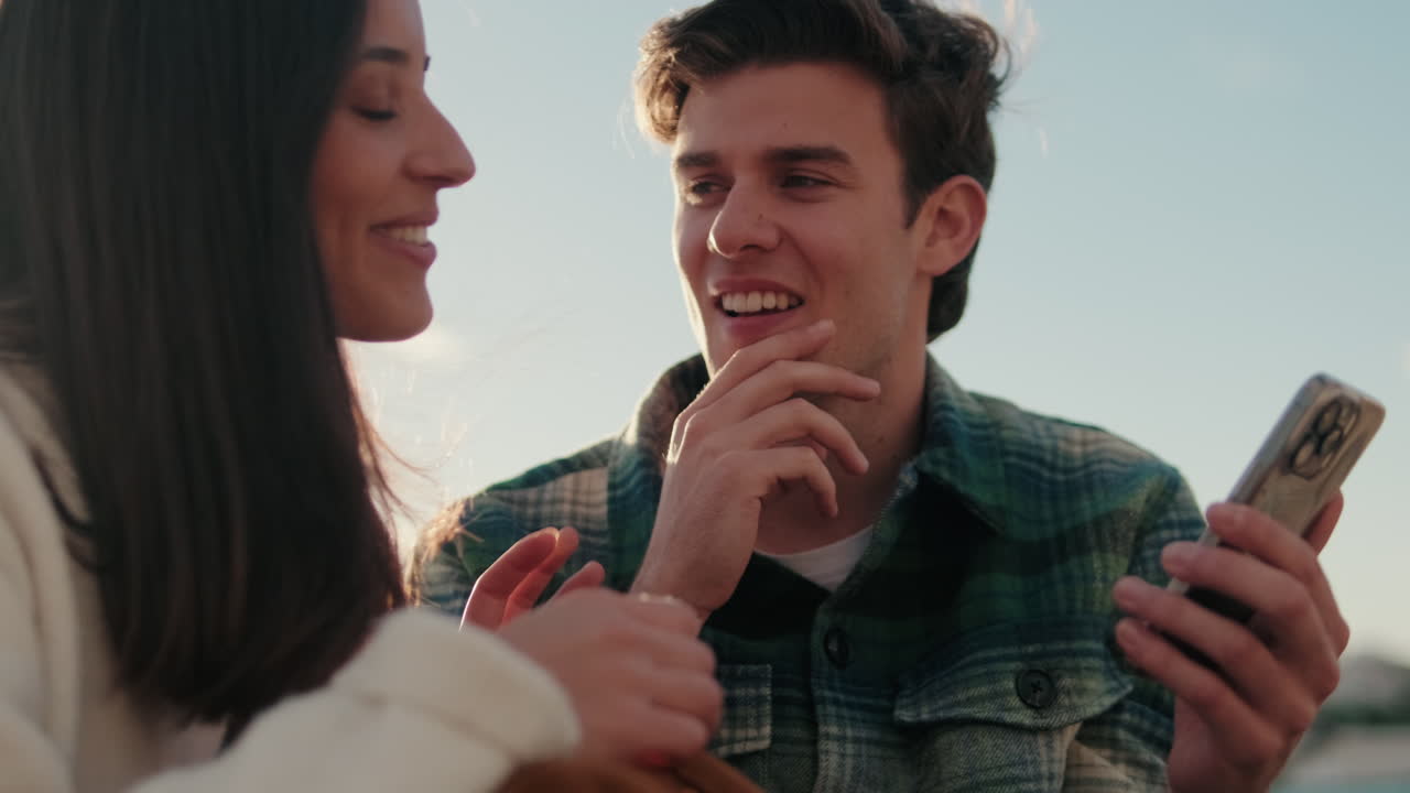 Happy Couple in Seville Sharing Photos on Phone