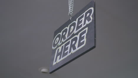 close up of an order here sign