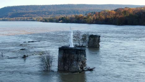 Statue-of-Liberty-watches-over-flooded-Susquehanna-River-in-autumn,-aerial-orbit-drone-shot