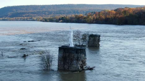 statue of liberty watches over flooded susquehanna river in autumn, aerial orbit drone shot