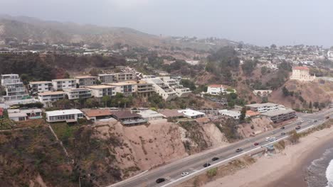 aerial low dolly shot along pacific coast highway near the sunset mesa and castellammare neighborhoods after the palisades fire in malibu, california. 4k