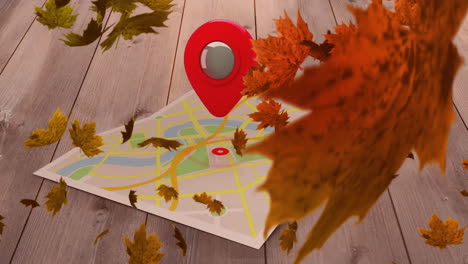 animation of leaves falling overlocation pin with map on wooden background