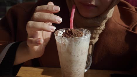 woman drinking a chocolate frappe