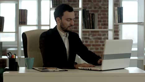 businessman finished work in front of a laptop