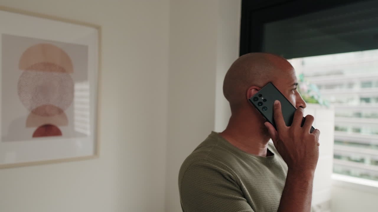 Bald Man on Phone Call at Home