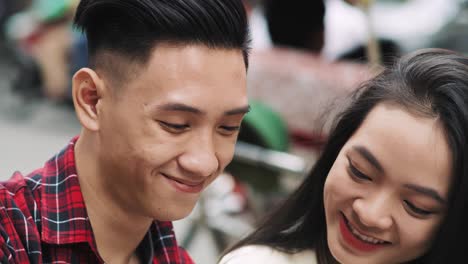 handheld view of young vietnamese couple making a selfie