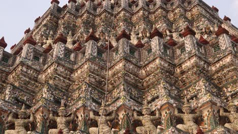 looking-up-at-towering-detailed-pagoda-spires-in-wat-arun-buddhist-temple-complex-in-the-Rattanakosin-old-town-of-Bangkok,-Thailand