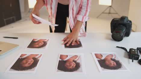 female photographer editing images from photo shoot in studio