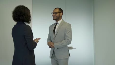 smiling employees meeting near door.