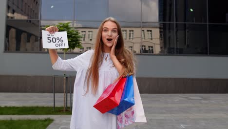 teen girl showing up to 50 percent off inscription, advertising discounts, shopping on black friday