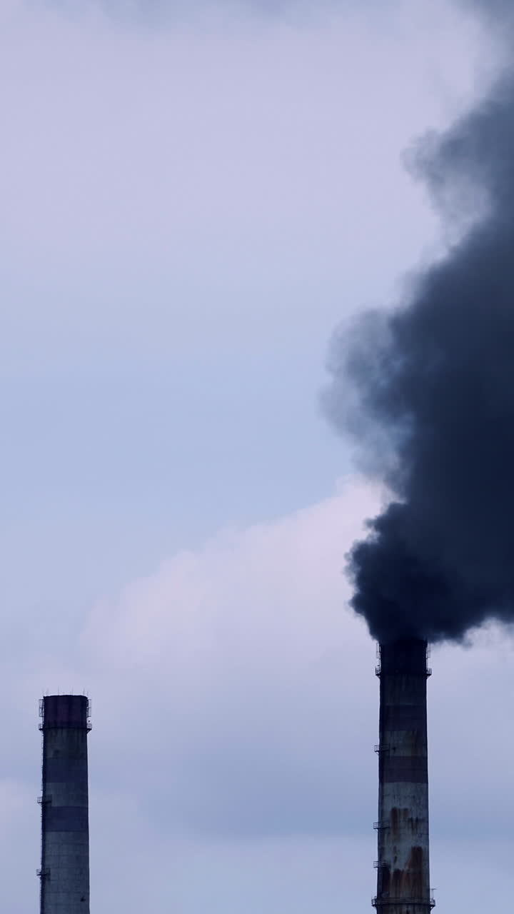 Factory pipe polluting air. Plant emits smoke and smog from the pipes