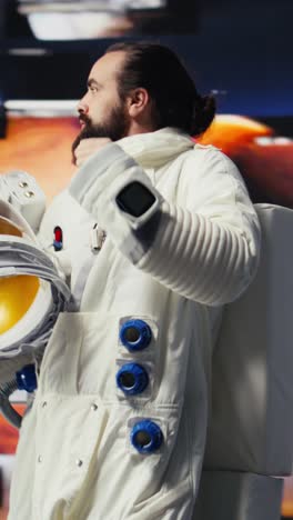 vertical video cosmonaut in a space suit exploring the world above earth