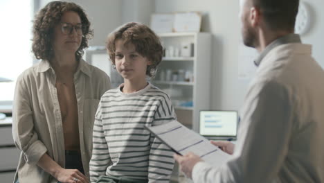 mother and little son getting medical consultation from pediatrician in clinic